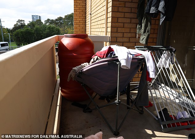 On Monday, large red chemical drums and piles of clothing were seen strewn along the balcony of a dilapidated unit.