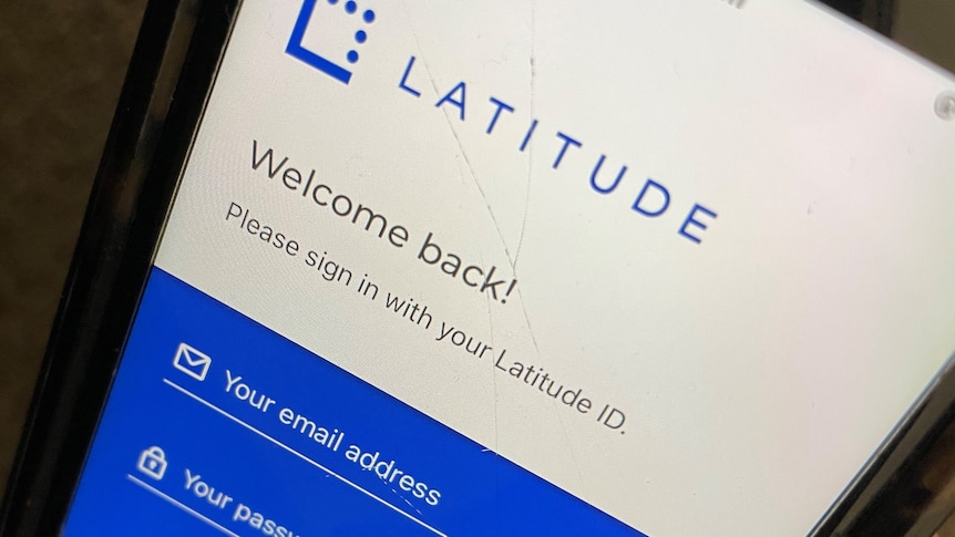 A person holds a smartphone with the Latitude Financial app open. 